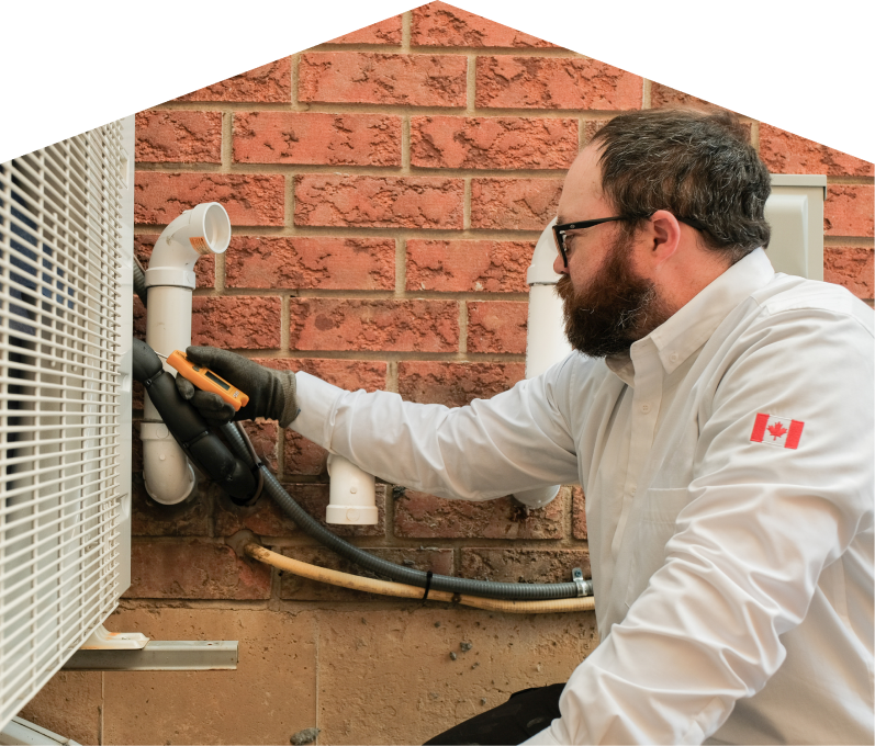 Peel HVAC specialist checking insulated piping on a heat pump unit beside a brick wall during a diagnostic service. Peel HVAC specialist checking insulated piping on a heat pump unit beside a brick wall during a diagnostic service.