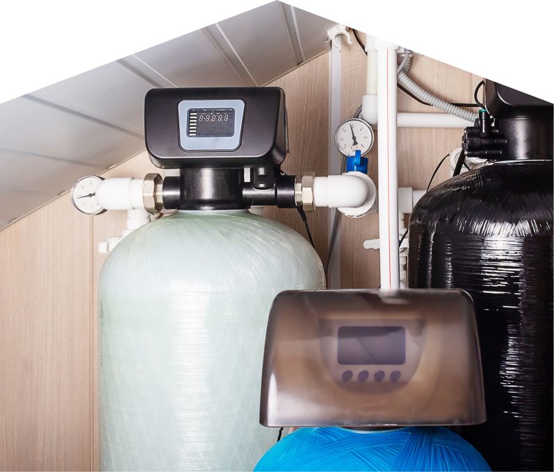 Peel home water filtration system featuring resin tanks, digital control heads, pressure gauges, and connected piping in a utility room. Peel home water filtration system featuring resin tanks, digital control heads, pressure gauges, and connected piping in a utility room.