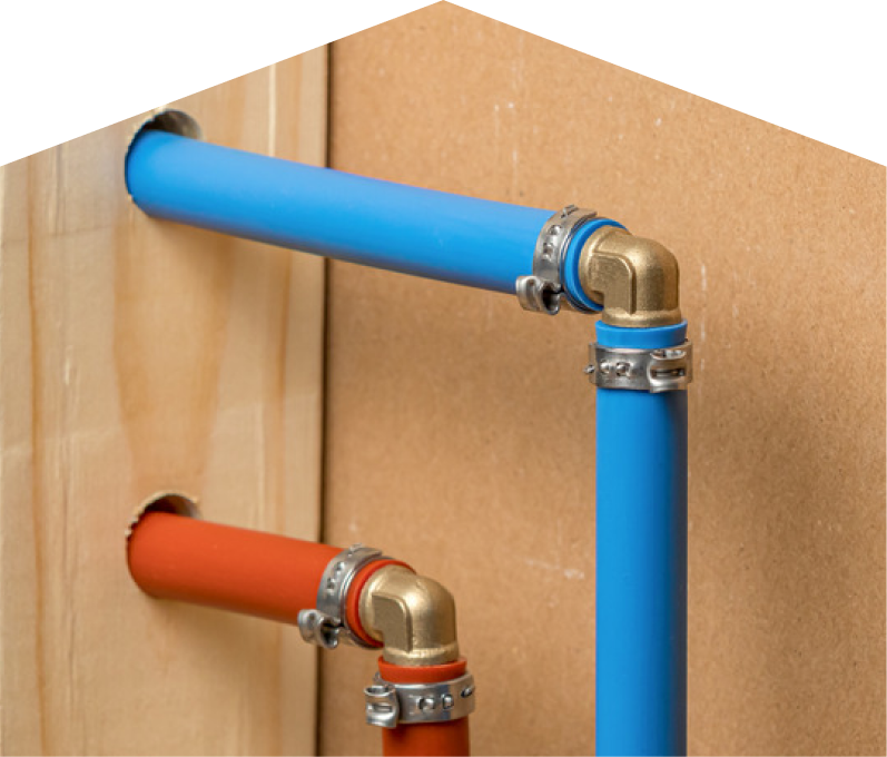 Peel kitec plumbing system with blue and orange plastic pipes connected by brass fittings and metal clamps, mounted on a wooden panel. Peel kitec plumbing system with blue and orange plastic pipes connected by brass fittings and metal clamps, mounted on a wooden panel.