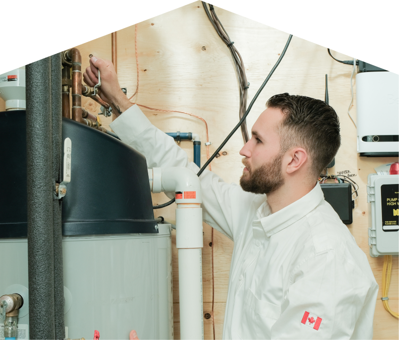 Peel water heater specialist adjusts piping on a large residential unit during a repair service, with exposed wood paneling and mounted utility components in the background. Peel water heater specialist adjusts piping on a large residential unit during a repair service, with exposed wood paneling and mounted utility components in the background.