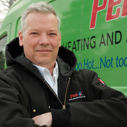 Peel technician standing by our famous green trucks in a residential neighbourhood. Peel technician standing by our famous green trucks in a residential neighbourhood.