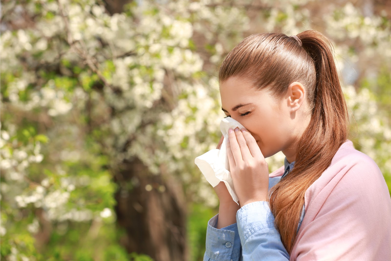 woman sneezing from allergies